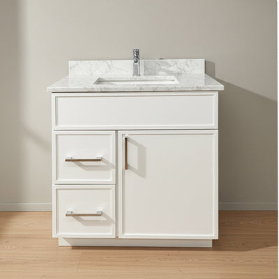White bathroom vanity with marble countertop and sink on a wooden floor.