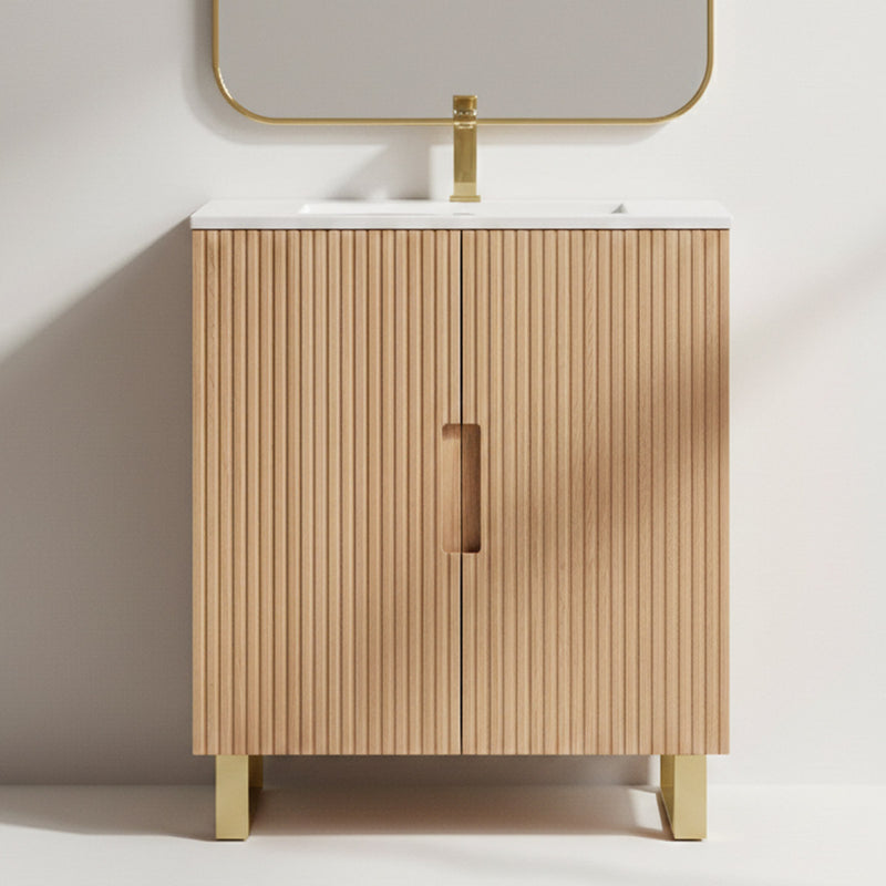 Wooden bathroom cabinet with white countertop and gold fixtures on a light gray background