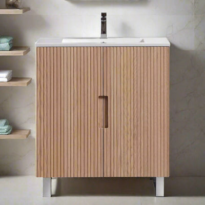 Wooden fluted bathroom vanity with sink against a light gray wall.
