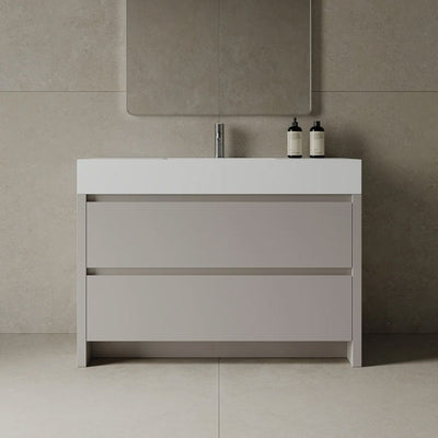Bathroom vanity with sink and mirror in a tiled bathroom setting