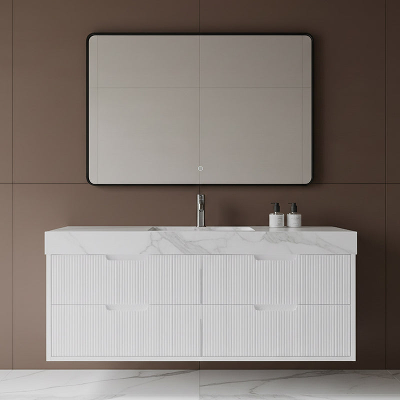 Bathroom vanity with white countertop, sink, and mirror against a brown wall.