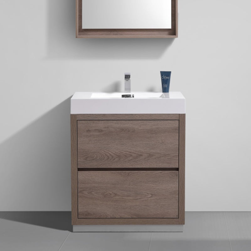 Bathroom vanity with wooden finish and white countertop against a gray wall.