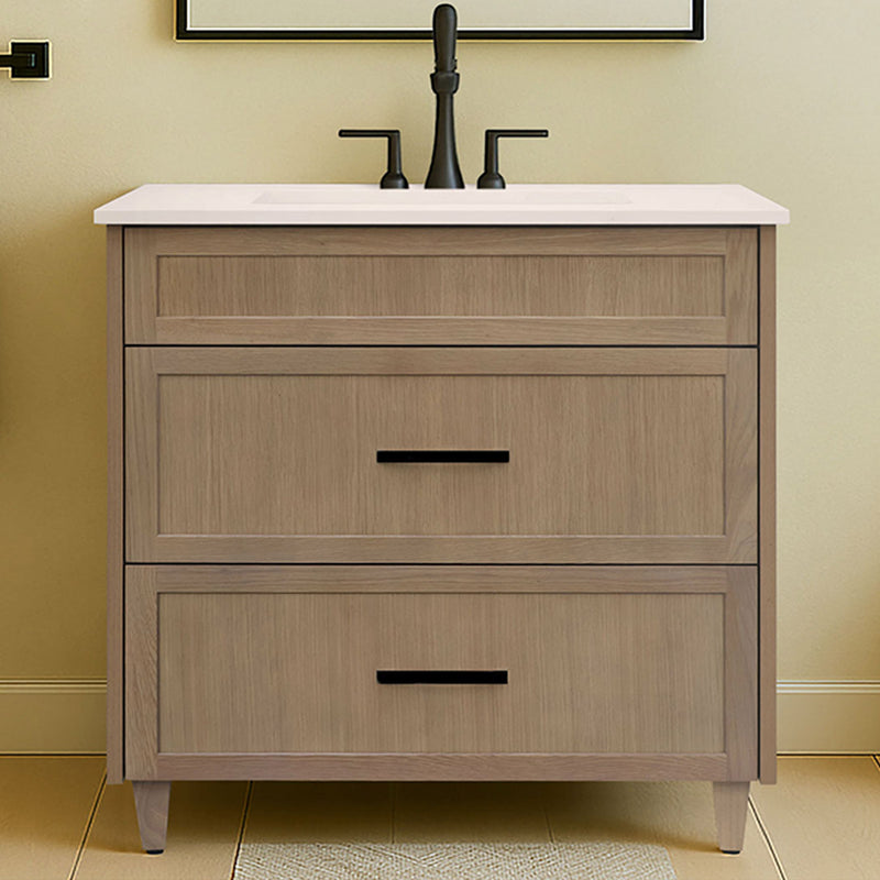 Bathroom vanity with wooden cabinet, white countertop, and black fixtures against a light wall.